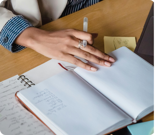 A person taking notes in a notebook.