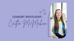 Cohort Spotlight on Caitlin McMahan. Smiling woman in white sweater and blue scarf sits in a bright room. Purple background with star doodles.